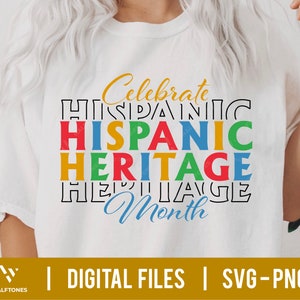 May include: White t-shirt with the text "Celebrate Hispanic Heritage Month" in colorful block letters.