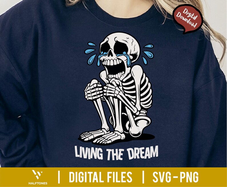 May include: Navy blue sweatshirt featuring a crying skeleton illustration. The skeleton is seated, with tears and the text "LIVING THE DREAM" in white. The design includes "DIGITAL FILES | SVG-PNG" at the bottom, with a "Digital Download" tag.