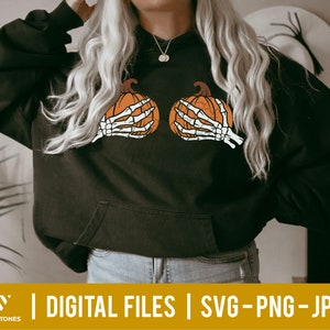 May include: A black hoodie with a skeleton hand holding a pumpkin on each side of the chest. The hoodie has a drawstring hood and a kangaroo pocket.