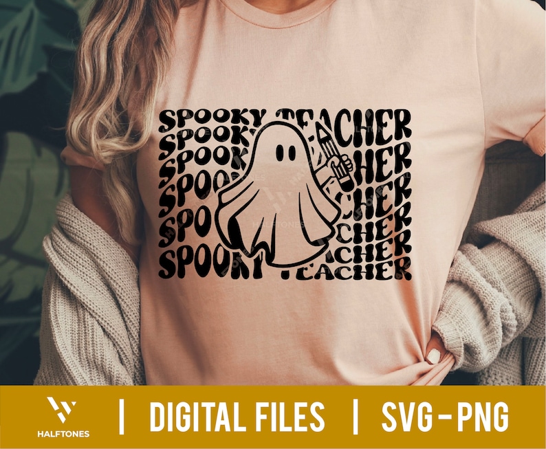 May include: A pink t-shirt with a black and white graphic of a ghost holding a pencil. The text "Spooky Teacher" is repeated in a wavy font around the ghost.