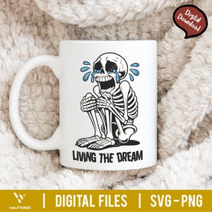 May include: White ceramic mug featuring a crying skeleton illustration with blue tears and the phrase "LIVING THE DREAM" in black. The mug has a curved handle and is labeled "Digital Download".