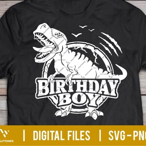 May include: Black t-shirt with a white graphic of a dinosaur with the text "Birthday Boy" in a circle around it.