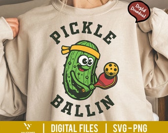 May include: A green pickle wearing a yellow headband and holding a pickleball paddle. The text "PICKLE BALLIN'" is above and below the pickle.