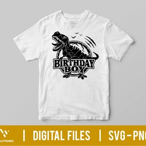 May include: A white t-shirt with a black graphic of a dinosaur with the text "Birthday Boy" in a circle.