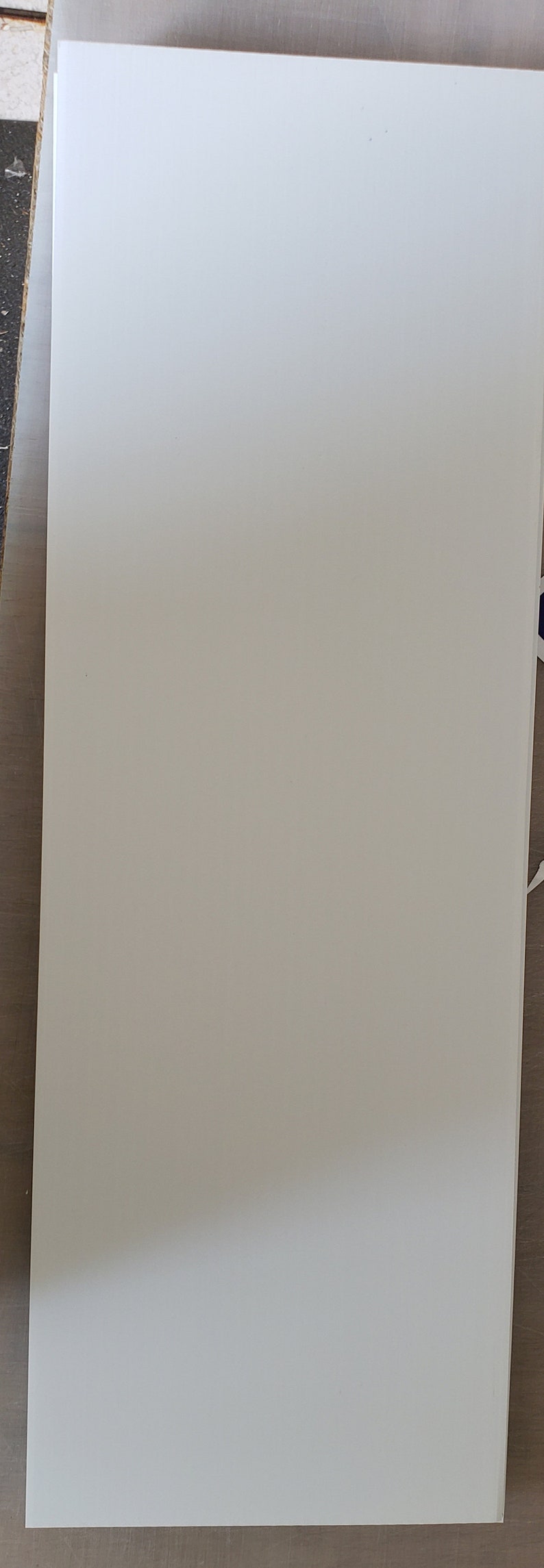 May include: A plain white sheet of paper.