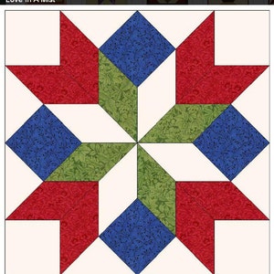 May include: A quilt block pattern called "Love In A Mist" with a white background and red, blue, and green fabric squares. The fabric squares have a floral pattern.