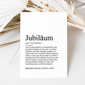 May include: A black and white printable art print with the German word "Jubil&auml;um" defined as a celebration of a special date with friends and colleagues. The print includes the definition, synonyms, and pronunciation of the word.