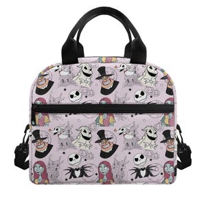May include: A light pink lunch bag featuring a repeating pattern of characters and scenes from The Nightmare Before Christmas, including Jack Skellington, Sally, Zero, and Oogie Boogie, with black handles, a front zipper pocket, and side clips.