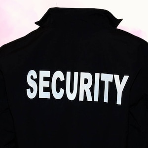 May include: Black security jacket with the word "SECURITY" printed in white reflective lettering on the back.