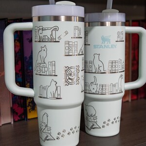 a couple of white cups sitting on top of a wooden table