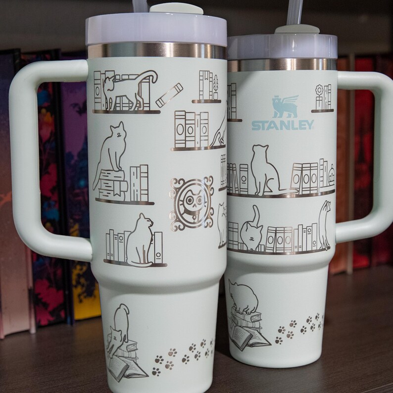 a couple of white cups sitting on top of a wooden table