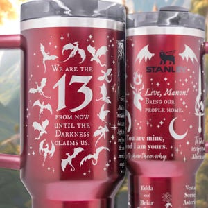 two red travel mugs sitting next to each other