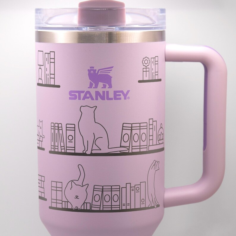a pink travel mug with a picture of a cat and a dog on it