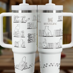 a couple of white coffee mugs sitting next to each other