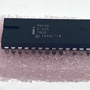 May include: A black integrated circuit chip with the text "P8238 6-505 7809 © INTEL '75" printed on it.