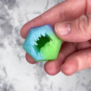 May include: A set of three ceramic mugs with a speckled, matte finish. The mugs are in shades of cream, light brown, and dark brown. Each mug has a simple, minimalist design, perfect for coffee or tea.