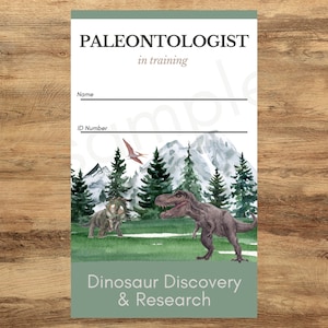May include: Paleontologist in training ID card with a watercolor illustration of a dinosaur, a flying reptile, and a mountain landscape. The card has spaces for a name and ID number. The text "Dinosaur Discovery & Research" is at the bottom of the card.