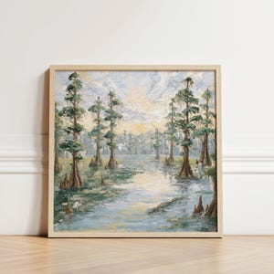 May include: Square framed oil painting of a swamp scene. The artwork depicts tall cypress trees with green foliage and textured bark, reflected in the water. The color palette includes greens, blues, and yellows, creating a serene landscape.