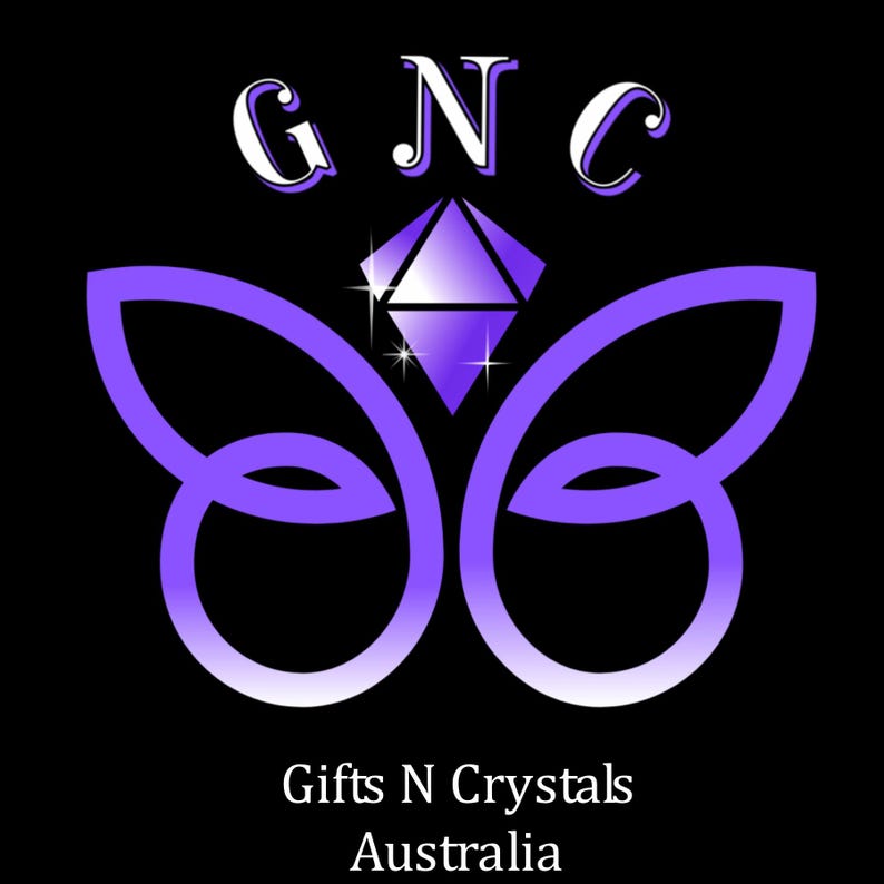 May include: A purple butterfly with a diamond in the center. The text "Gifts N Crystals Australia" is below the butterfly.
