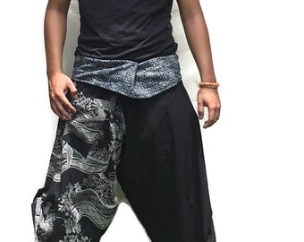 May include: Black and white patterned pants with a black sleeveless shirt and a silver belt. The pants are loose fitting and have a wide leg.