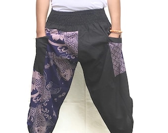 May include: Black pants with a purple and blue patterned design featuring koi fish. The pants have a wide, elastic waistband and side pockets.