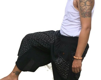 May include: Black and white patterned pants with a drawstring waist and side pockets. The pants are cuffed at the bottom and have a loose, comfortable fit.