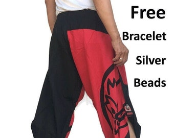 May include: Black and red pants with a graphic print of a stylized animal. The pants have a wide leg and a drawstring waist. Free bracelet with silver beads is included.