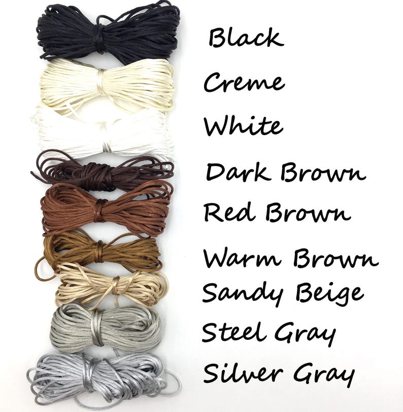 May include: A collection of colorful cords in various shades, including black, cream, white, and several shades of brown and gray. The image also includes the text labels: Black, Creme, White, Dark Brown, Red Brown, Warm Brown, Sandy Beige, Steel Gray, and Silver Gray.