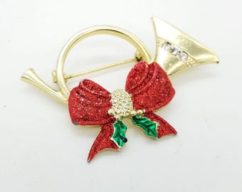 Vintage Golden Horn & Red Bow Holiday Brooch With Green Enamel and Rhinestones