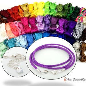 May include: A collection of colorful satin cord bundles in various shades, including red, orange, yellow, green, blue, and purple. A close-up shows a purple cord necklace with silver clasps and a small silver tag. The image showcases craft supplies.