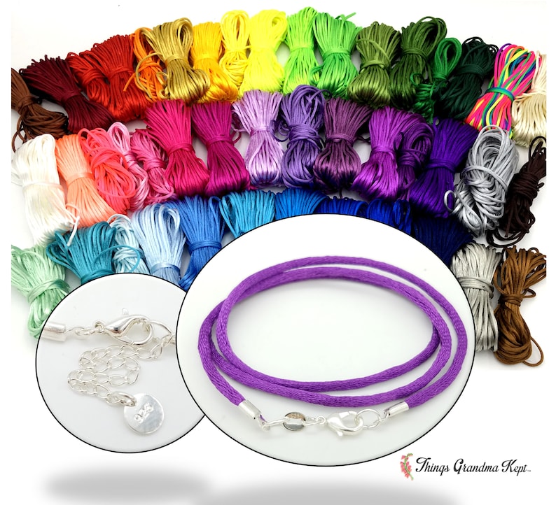 May include: A collection of colorful satin cord bundles in various shades, including red, orange, yellow, green, blue, and purple. A close-up shows a purple cord necklace with silver clasps and a small silver tag. The image showcases craft supplies.