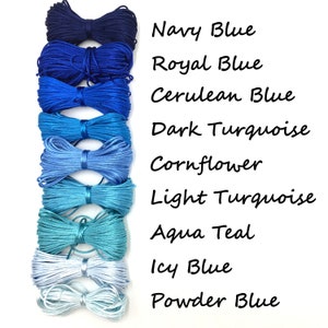 May include: A collection of nine spools of cord in various shades of blue, from navy to powder blue. The image includes text labels for each color: Navy Blue, Royal Blue, Cerulean Blue, Dark Turquoise, Cornflower, Light Turquoise, Aqua Teal, Icy Blue, and Powder Blue.