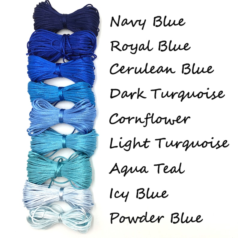 May include: A collection of nine spools of cord in various shades of blue, from navy to powder blue. The image includes text labels for each color: Navy Blue, Royal Blue, Cerulean Blue, Dark Turquoise, Cornflower, Light Turquoise, Aqua Teal, Icy Blue, and Powder Blue.