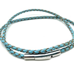 May include: A light blue braided cord bracelet featuring a polished silver-tone cylindrical clasp. The bracelet is designed to wrap around the wrist multiple times, showcasing a consistent woven texture throughout the length of the cord.