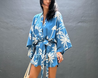 May include: A blue kimono-style outfit with a white palm tree pattern. The outfit includes a wrap top with wide sleeves and matching shorts. A matching belt cinches the waist. The text "STYLE DARK" is visible on the outfit.