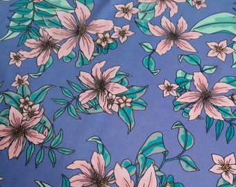 May include: Purple fabric with a pink floral pattern. The flowers are stylized and have a light pink color with a darker pink center. The leaves are a teal green color.
