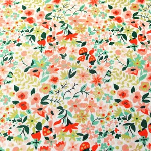 May include: A white fabric with a repeating pattern of pink, red, and green flowers. The flowers are stylized and have a whimsical feel.