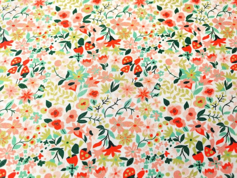 May include: A white fabric with a repeating pattern of pink, red, and green flowers. The flowers are stylized and have a whimsical feel.