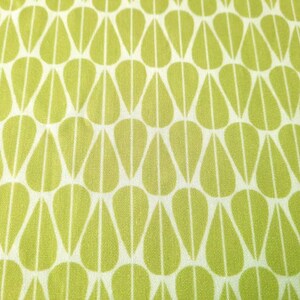 May include: A white fabric with a repeating pattern of green teardrop shapes.