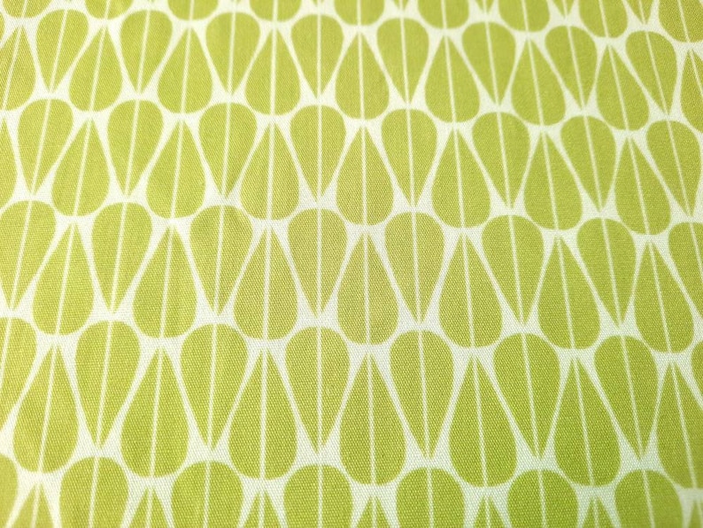 May include: A white fabric with a repeating pattern of green teardrop shapes.