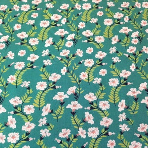 May include: Teal fabric with a white floral pattern. The flowers are small and have a pink center. The fabric has a subtle sheen.