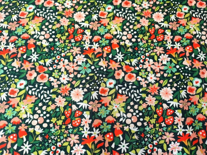 May include: A dark green fabric with a repeating pattern of pink, red, and white flowers, leaves, and mushrooms.