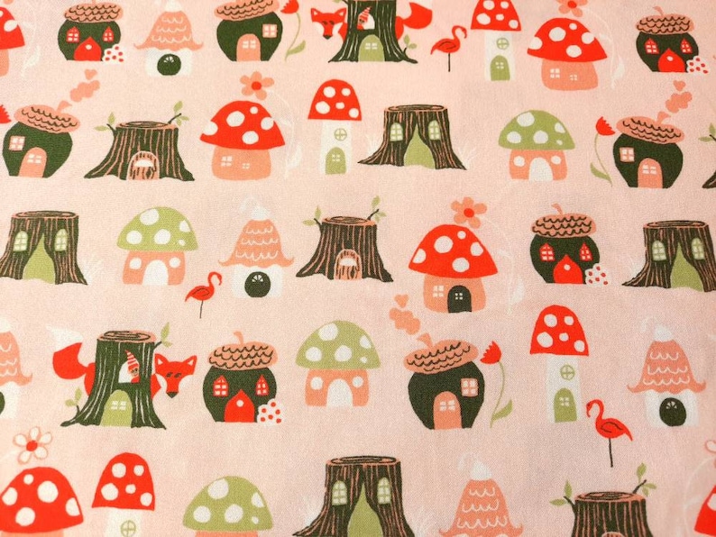 May include: A pink fabric with a repeating pattern of mushroom houses, tree stumps, and foxes. The houses are in various colors, including red, green, and brown. The tree stumps are brown and have a rough texture. The foxes are orange and have white tails.