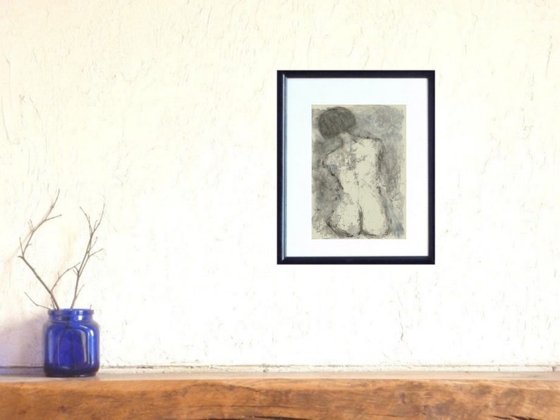 May include: A black and white drawing of a nude figure in a seated pose, framed in a black frame.