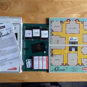 May include: A green and white magnetic pocket edition of the board game Clue? The game board features a mansion with rooms like the kitchen, ballroom, conservatory, billiard room, library, study, lounge, hall, and dining room. The game includes murder cards, character cards, and weapon cards.
