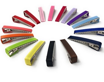 May include: Assortment of 14 hair clips in various colors, including red, pink, purple, blue, green, yellow, orange, brown, and black. The clips are made of metal and have a ribbed texture.
