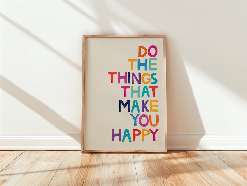 May include: A framed print with the text "Do the things that make you happy" in a colorful rainbow font.