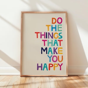 May include: A framed print with the text "Do the things that make you happy" in colorful letters on a white background.