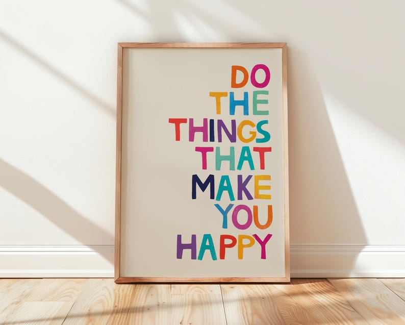 May include: A framed print with the text "Do the things that make you happy" in colorful letters on a white background.