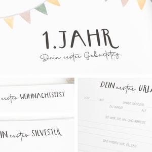May include: A white page with black text that says "1. JAHR Dein erster Geburtstag" and "DEIN erster URLAUB". There are sections for "VOM", "BIS", "DU WARST", "UNSER REISEZIEL", "ALT", "SO WAR DIE AN- UND ABREISE", and "DAS HABEN WIR ERLEBT". There is also a section that says "DEIN erster WEIHNACHTSFEST" and "DEIN erster SILVESTER".